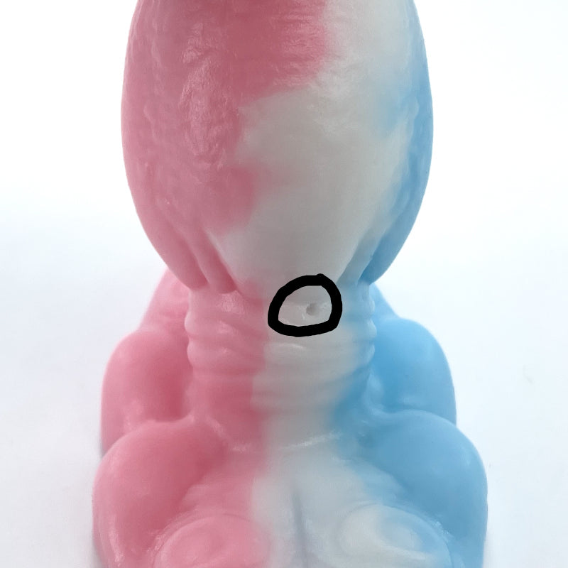 Colorful silicone mold with pink, white, and blue sections on a white background